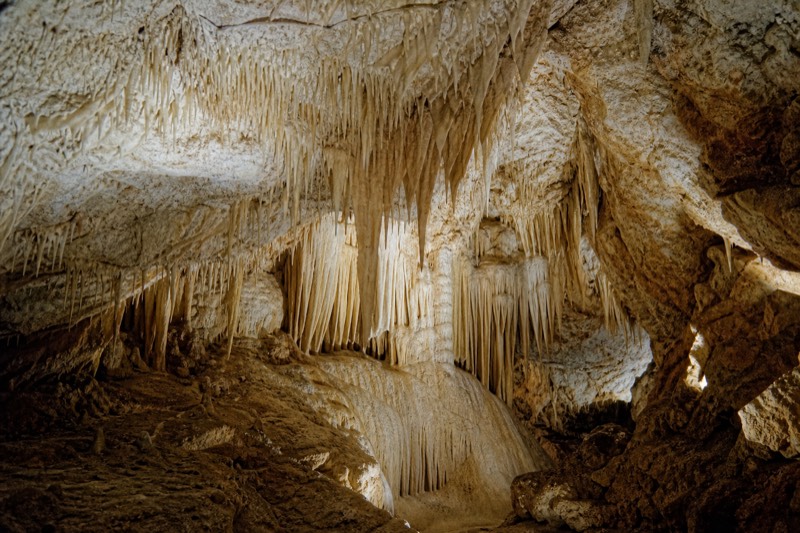 Dense white stalactites and flowstone in the dry Aranui Cave at Waitomo, which has no glowworms