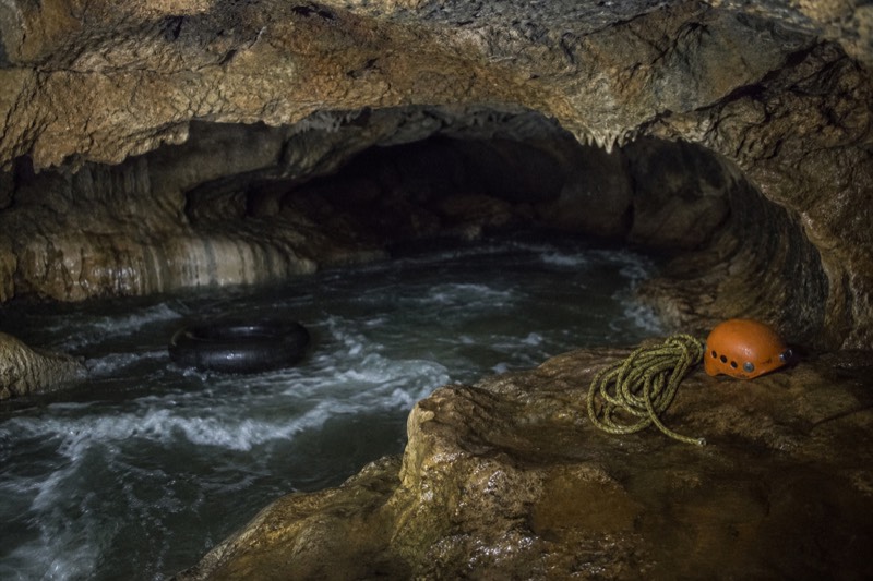 An inner tube floating in a fast underground stream inside Ruakuri Cave, where Waitomo black water rafting runs